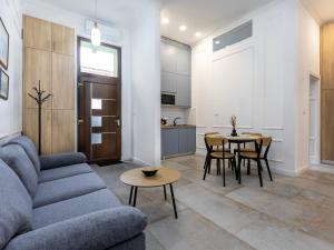 a living room with a couch and a table at Central View Garden in Oradea