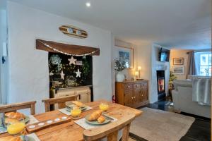 a living room with a wooden table with food on it at Finest Retreats - Cawsand Cottage in Cawsand