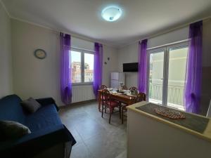 a living room with a blue couch and a table at 200m from Beach, New Central Apt, AC, WiFi in Loano
