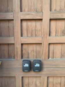 two clocks sitting on a wooden fence at 4 tea 4 house in Romano Canavese