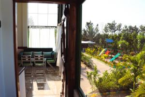 a view from a window of a patio with a pool at Nature's Spark Resort in Sivasamudram