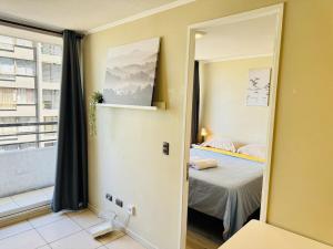 a small room with a bed and a window at Estancia para 3 cerca de Metro in El Cerrillo +5 photos