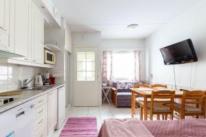 a kitchen with a table and a dining room at Moonlight 310 Visit Levi in Levi