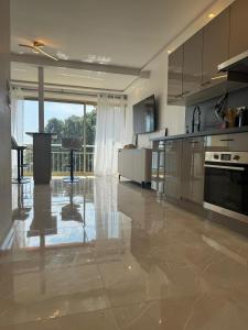 a large kitchen with stainless steel appliances and a large window at Luxury Apartment with Sea View and Private Beach Access in Cannes