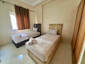 a bedroom with two beds and a window at Luxury Apartment - Fes Medina in Fès