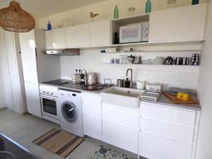 a kitchen with a sink and a washing machine at Les Cavaliers in Cabourg +21 photos
