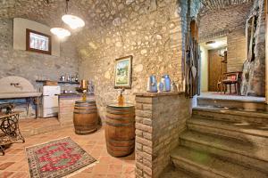 a room with three wooden barrels and a kitchen at Agriturismo Cascina Crocelle - Lake View and Heated Pool in Padenghe sul Garda
