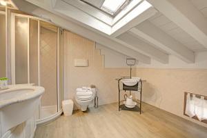 a bathroom with a sink toilet and a skylight at Agriturismo Cascina Crocelle - Lake View and Heated Pool in Padenghe sul Garda +109 photos
