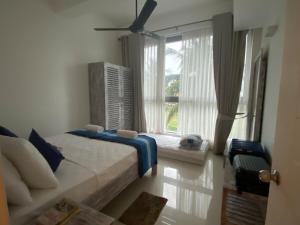 a bedroom with a bed and a large window at The Turtle Galle condo in Galle +24 photos