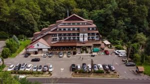 an aerial view of a building with a parking lot at Hotel Fantanita Haiducului in Bradu