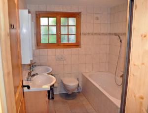 a bathroom with a sink and a tub and a toilet at Cresta in Fiesch +42 photos