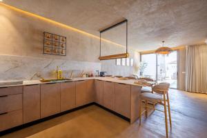 a kitchen with a sink and a counter with a table at וילה כוכב המדבר in Eilat