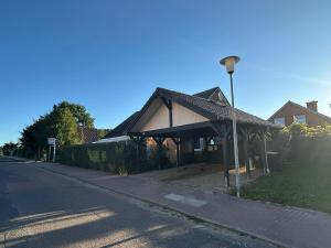a building on the side of a street with a street light at "Beim Meer" in Pelzerhaken +6 photos