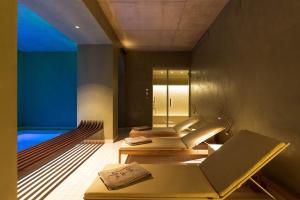 a spa room with two beds and a mirror at Hôtel Spa & Restaurant - Son de Mar in Porto-Vecchio