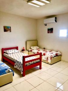 a bedroom with two beds and a air conditioner at Bujtina Gashi Relax Nature 