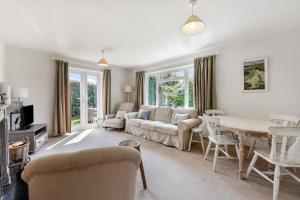 a living room with a couch and a table at 21 Owers Way, West Wittering in West Wittering