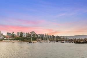 a group of boats are docked in a harbor at The Garden Townhome - Heart Of Wollongong in Wollongong