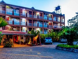 a large building with a giraffe in front of it at African Tribe Hotel in Kampala