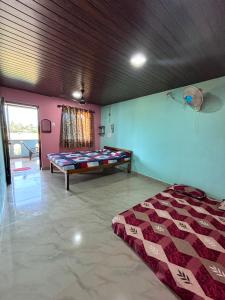 a bedroom with a bed in the corner of a room at dream way in Gokarna +28 photos