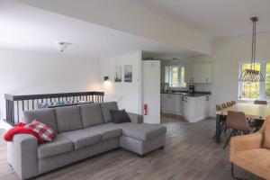 a living room with a couch and a kitchen at Nature & Breathtaking View - Le Dumont - A in Saint-Philémon