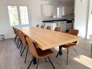 a large wooden table and chairs in a room at Nature & Breathtaking View - Le Dumont - A in Saint-Philémon