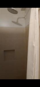 a bathroom with a shower with a shower curtain at Condominium Luxury 1 bedroom, impressive amenities in Davao City