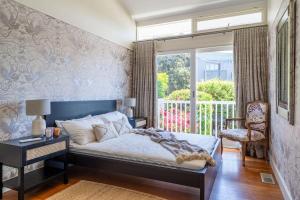 a bedroom with a bed and a window at The Bungan - Beachfront W Access To Bungan Beach in Newport