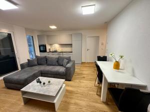 a living room with a couch and a table at Haus Römerhof Apt 3 in Brig