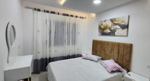a bedroom with a bed with pink pillows on it at Dar ATTIA Ezzahra KELIBIA in Ḩammām al Ghazzāz