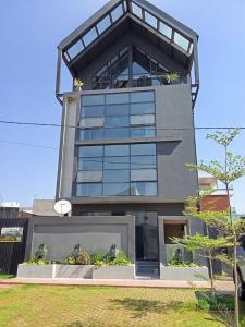 a tall building with glass windows on top of it at BuSoBlack in Maputo