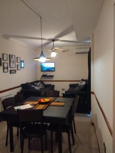 a living room with a table and a couch at Departamento Céntrico Miralejos 3 in Villa Carlos Paz