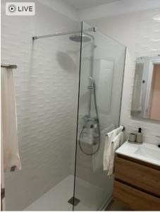 a glass shower in a bathroom with a sink at Casa Caletillas in Candelaria