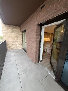 a patio with a door and a brick wall at Modern Double Room near Canary Wharf and Excel in Moffat