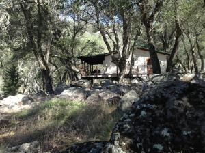 a house in the woods with rocks and trees at Glamping Bell Tent Escape on Palomar Mountain in Pauma Valley