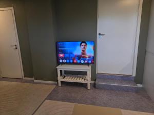 a flat screen tv sitting on a wall in a room at Small cozy 3 bed appartment in Tromsø