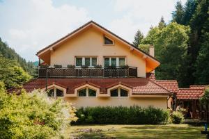 a house with a balcony on top of it at Pri Piecke penzión a reštaurácia in Staré Hory