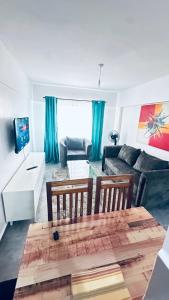 un salon avec une table et un canapé dans l'établissement Vaiyonce Residences, à Kisumu