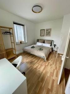 a bedroom with a bed and a wooden floor at Zur Hirschstraße 10 in Haslach