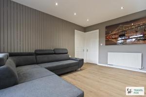 a living room with a couch and a painting on the wall at Rosie's Central House With Drive Parking in Nottingham