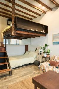 a room with a bunk bed and a couch at duplex 1 bedroom apartment on Wuyuan Road close Changshu Road station in Shanghai