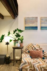 a bedroom with two potted plants and a table with a bed at duplex 1 bedroom apartment on Wuyuan Road close Changshu Road station in Shanghai