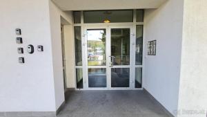 an entrance to a building with a glass door at Maj 1, 1207 in Liptovský Mikuláš +2 photos