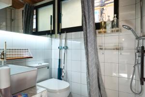 a bathroom with a toilet and a shower at duplex 1 bedroom apartment on Wuyuan Road close Changshu Road station in Shanghai +24 photos