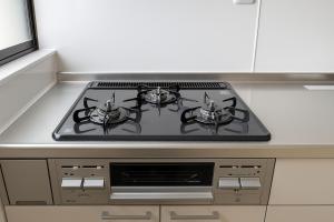 a stove top with two pots on it in a kitchen at BEYOND HOTEL Takayama 5th in Takayama