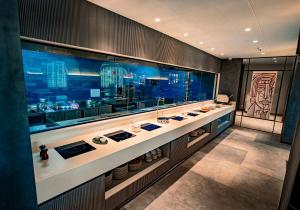 a bathroom with a counter with bowls and sinks at Welina Hotel in Bhubaneshwar