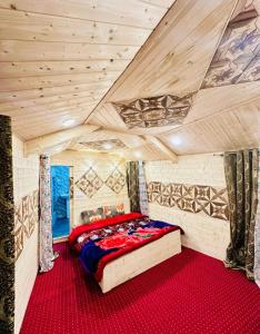 a bedroom with a bed in a room with wooden ceilings at Little blue Moon in Srinagar