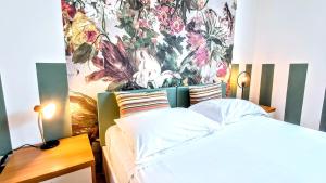 a bedroom with a bed with a floral mural on the wall at COUNTRY & SHABBY CHiC -CENTRAL TOP FLOOR- in Trento