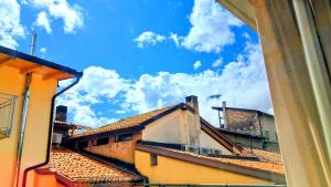 a view of the roofs of buildings from a window at COUNTRY & SHABBY CHiC -CENTRAL TOP FLOOR- in Trento