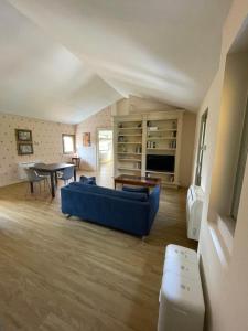 a living room with a blue couch and a table at VILLA VALLE FRANCIACORTA - Appartamenti per vacanze in Rodengo Saiano