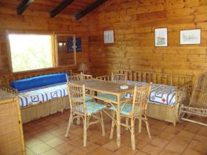 a dining room with a table and chairs in a cabin at Serena Holiday Home in Marina di Camerota